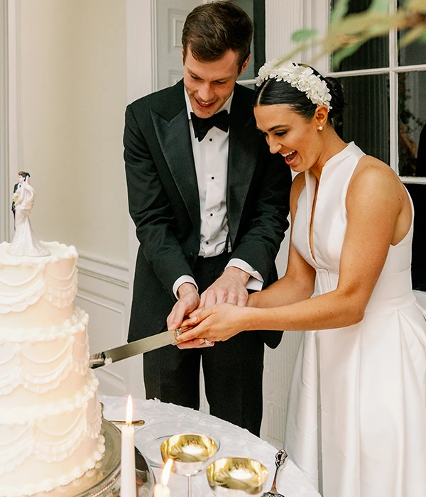 A  newly married couple cutting their wedding cake in  Charleston, SC